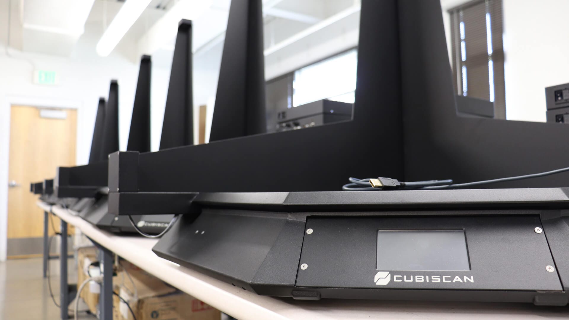 Cubiscan-Certified-Hero-Image Cubiscan 100 dimensioning systems lined up on a table