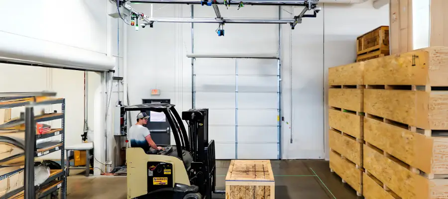 pallet scanner with the 1200 system man scanning a broom head for the purpose of slotting or warehouse pick and pack using dimensioning systems
